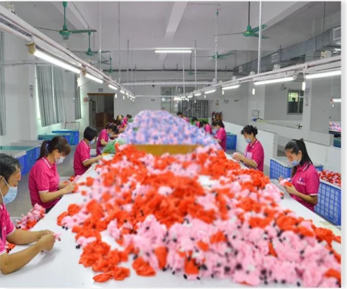 Factory team hand-finishing plush pieces during production